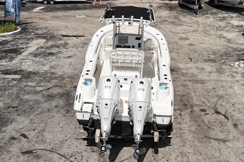 Slide: The Image of 2024 Key West 244 CC boat with dual engines, viewed from the rear on a concrete surface. - 17