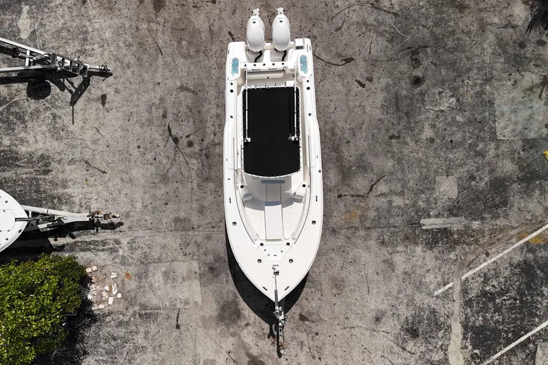 Slide: The Image of 2024 Key West 244 CC boat, aerial view, parked on concrete surface. - 18