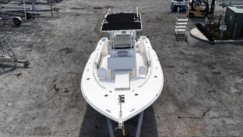 Slide: The Image of 2024 Key West 244 CC boat with T-top, docked on a concrete surface. - 19