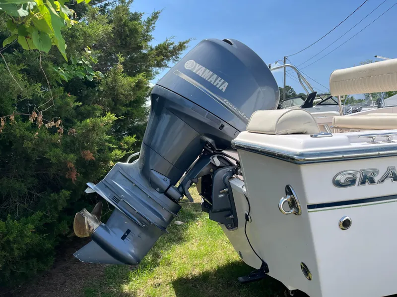 Slide: The Image of 2012 Grady-White Fisherman 180 boat with Yamaha outboard motor, parked near greenery. - 2