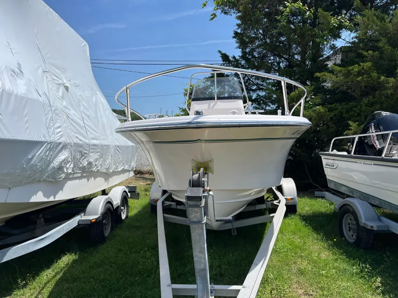 Slide: The Image of 2012 Grady-White Fisherman 180 boat on trailer, parked outdoors, surrounded by trees. - 4