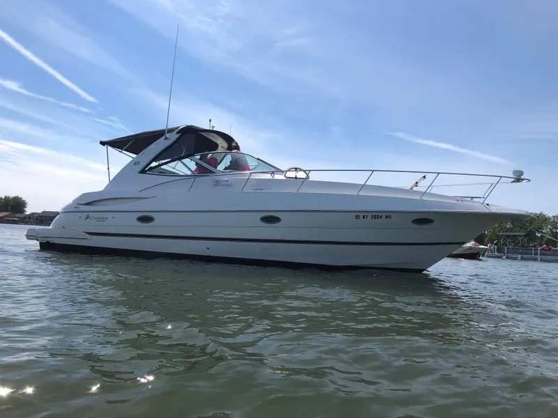Slide: The Image of 2004 Cruisers Yachts 340 Express on water under clear blue sky. - 0