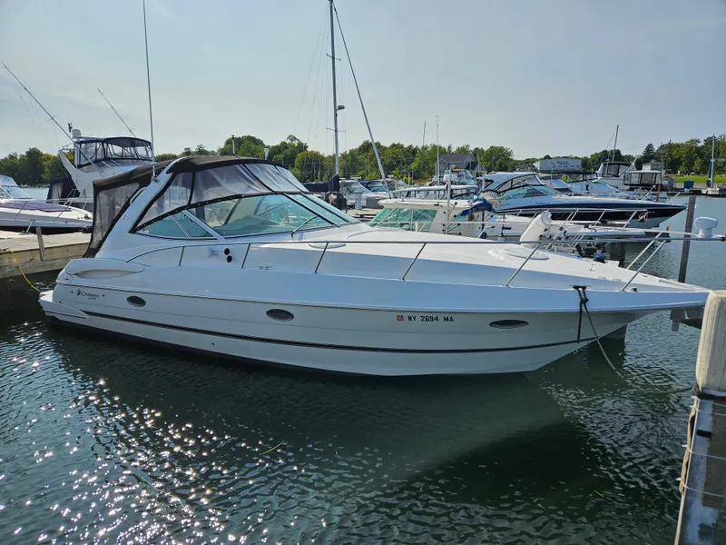 Slide: The Image of 2004 Cruisers Yachts 340 Express docked at a marina, surrounded by other boats. - 1