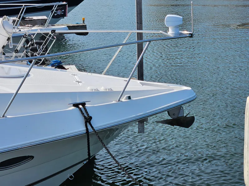 Slide: The Image of 2004 Cruisers Yachts 340 Express docked in calm marina waters. - 10