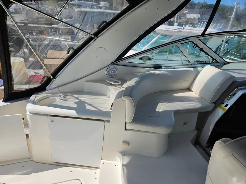 Slide: The Image of 2004 Cruisers Yachts 340 Express interior with white seating and sleek design. - 15