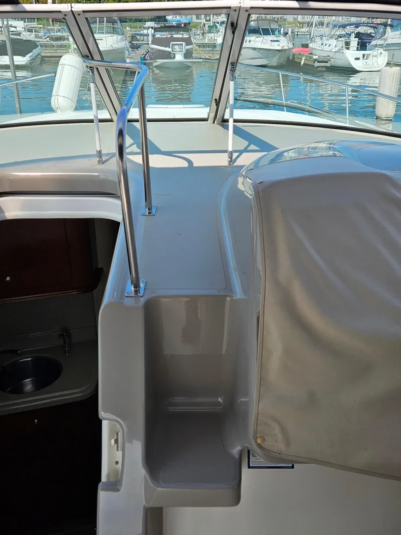 Slide: The Image of 2004 Cruisers Yachts 340 Express interior with marina view in the background. - 19