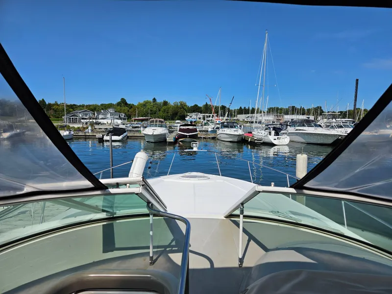Slide: The Image of 2004 Cruisers Yachts 340 Express docked at a marina with clear blue skies. - 20