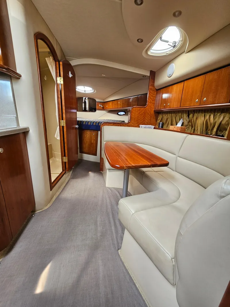 Slide: The Image of 2004 Cruisers Yachts 340 Express interior with elegant wood finishes and comfortable seating. - 30