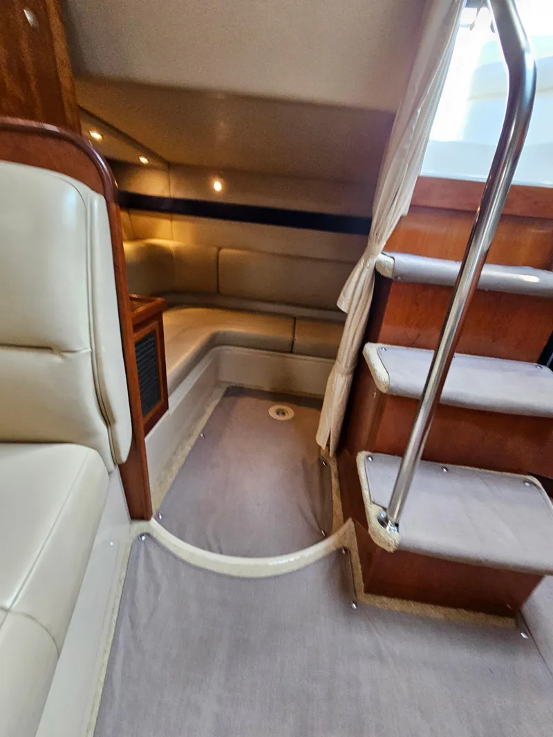 Slide: The Image of Interior of 2004 Cruisers Yachts 340 Express, featuring stairs and seating area. - 37