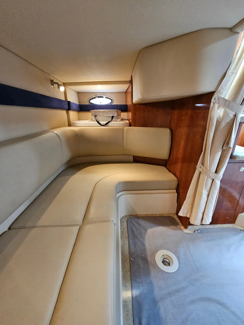 Slide: The Image of 2004 Cruisers Yachts 340 Express interior with beige seating and wood accents. - 39
