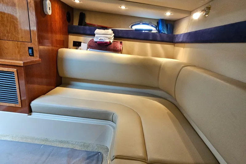Slide: The Image of 2004 Cruisers Yachts 340 Express interior with beige seating and wooden accents. - 41