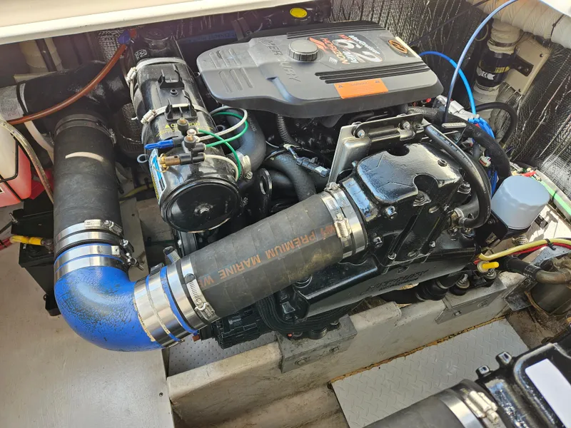 Slide: The Image of 2004 Cruisers Yachts 340 Express engine compartment with visible components and hoses. - 45