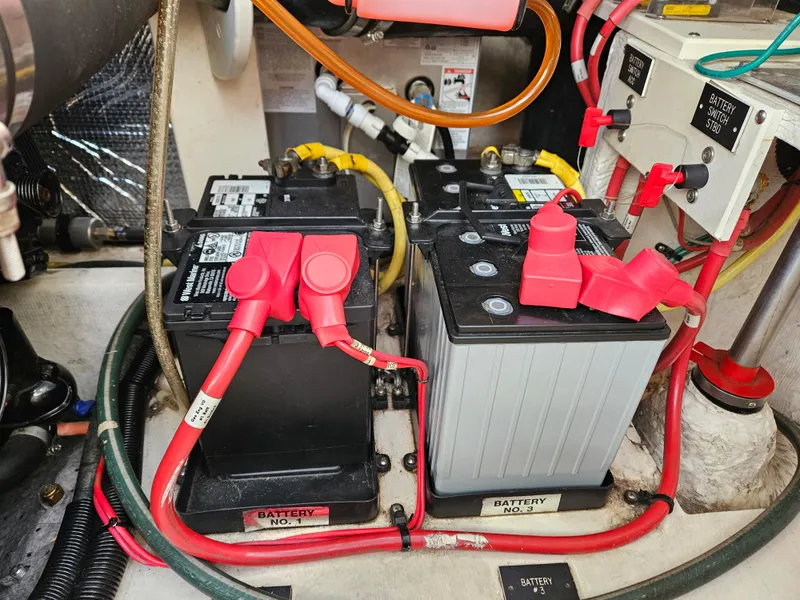 Slide: The Image of 2004 Cruisers Yachts 340 Express engine compartment with dual batteries and wiring. - 46