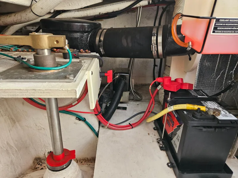 Slide: The Image of Engine compartment of a 2004 Cruisers Yachts 340 Express, featuring battery and wiring components. - 47