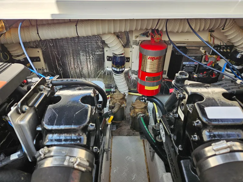 Slide: The Image of Engine room of 2004 Cruisers Yachts 340 Express with dual engines and fire extinguisher. - 48