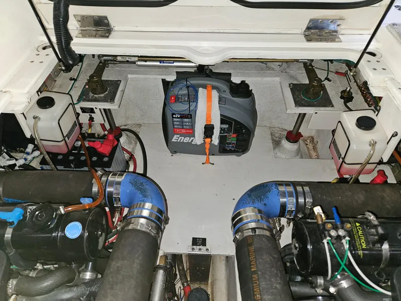 Slide: The Image of Engine compartment of 2004 Cruisers Yachts 340 Express with visible components and wiring. - 49