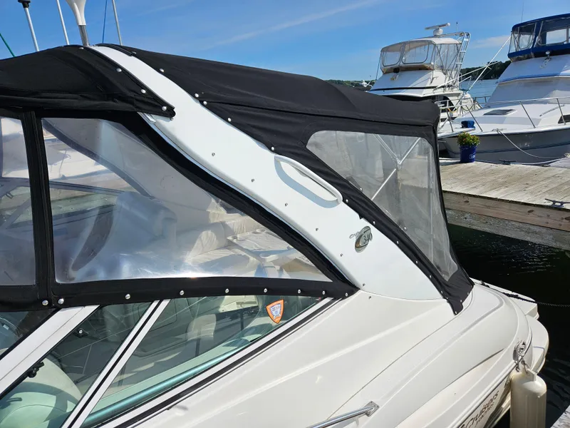 Slide: The Image of 2004 Cruisers Yachts 340 Express with black canopy docked at marina. - 5