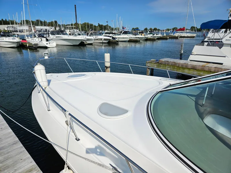 Slide: The Image of 2004 Cruisers Yachts 340 Express docked in a marina, surrounded by other boats. - 7
