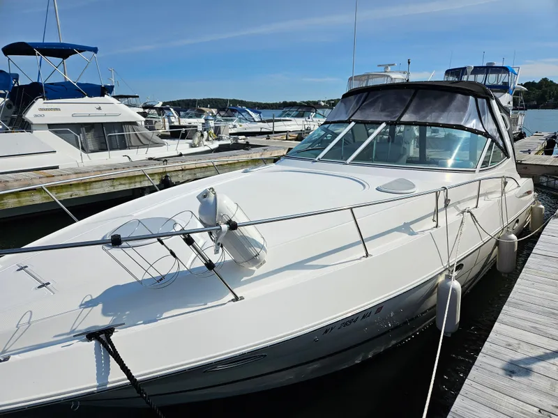 Slide: The Image of 2004 Cruisers Yachts 340 Express docked at marina under clear sky. - 8