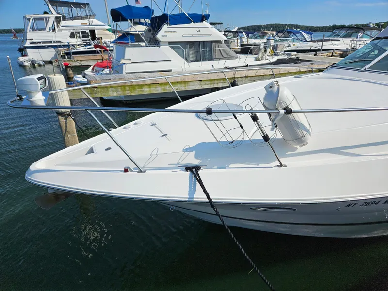 Slide: The Image of 2004 Cruisers Yachts 340 Express docked at marina, surrounded by other boats. - 9
