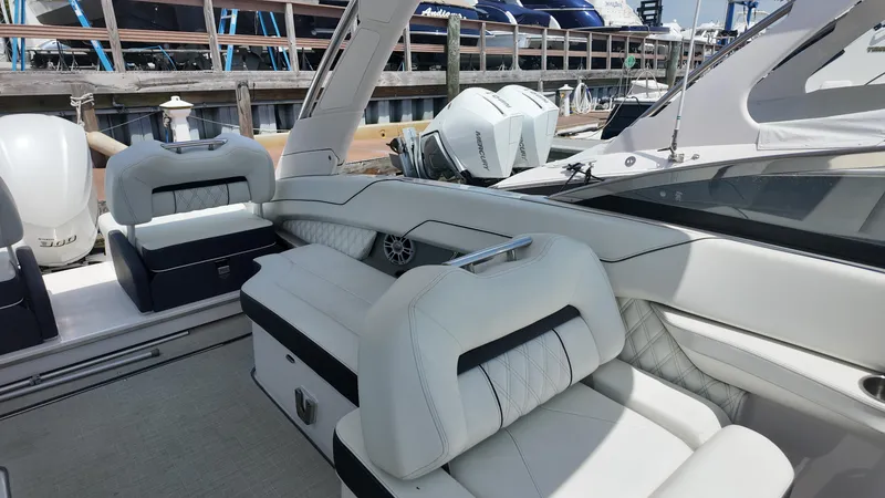 Slide: The Image of 2021 Regal LX6 boat interior with luxurious white seating and modern design. - 10