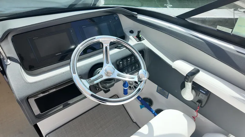 Slide: The Image of 2021 Regal LX6 boat dashboard with steering wheel and control panel. - 11