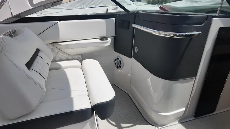 Slide: The Image of 2021 Regal LX6 boat interior with white seating and sleek black accents. - 14