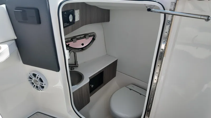 Slide: The Image of 2021 Regal LX6 boat interior bathroom with sink, toilet, and storage. - 15