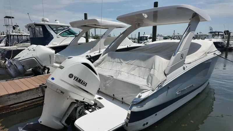 Slide: The Image of 2021 Regal LX6 boat with Yamaha engine docked at marina. - 2