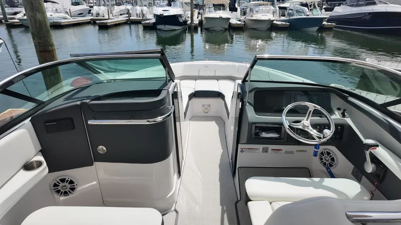 Slide: The Image of Interior view of a 2021 Regal LX6 boat docked at a marina. - 20
