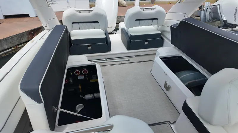 Slide: The Image of 2021 Regal LX6 boat interior with open storage compartments and cushioned seating. - 22