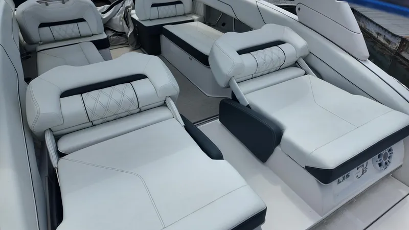Slide: The Image of 2021 Regal LX6 boat interior with luxurious white seating and modern design. - 23
