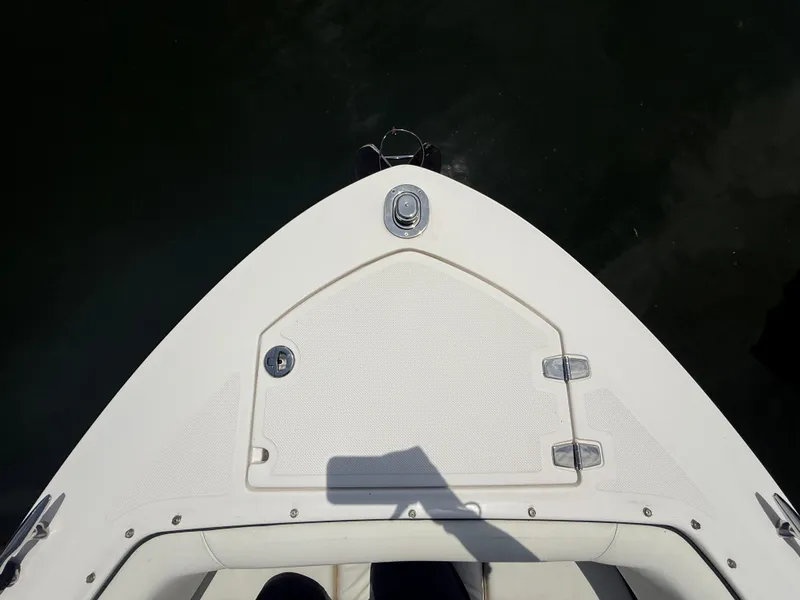 Slide: The Image of Bow of 2021 Regal LX6 boat with storage hatch, viewed from above. - 24