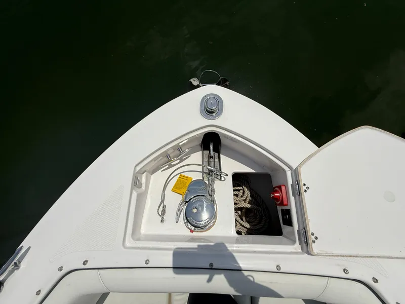 Slide: The Image of Bow storage area of a 2021 Regal LX6 boat with anchor and rope. - 25