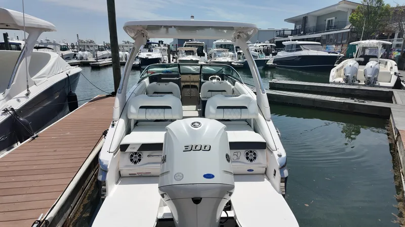 Slide: The Image of 2021 Regal LX6 boat docked at a marina, showcasing sleek design and powerful engine. - 3