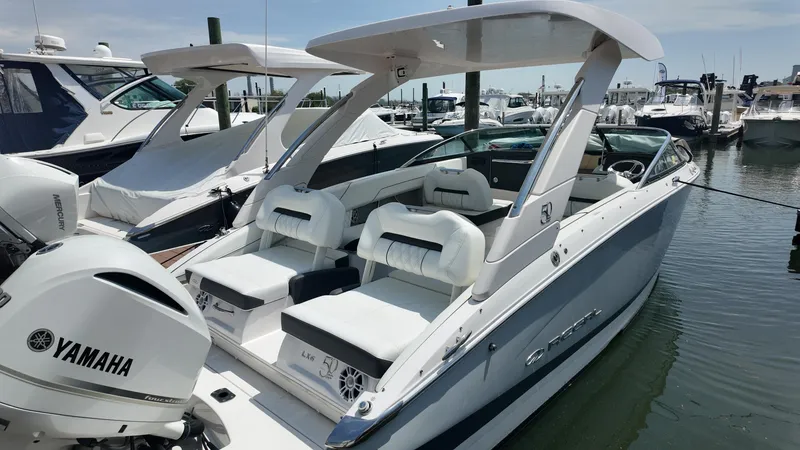 Slide: The Image of 2021 Regal LX6 boat docked, featuring Yamaha engines and luxurious seating. - 4