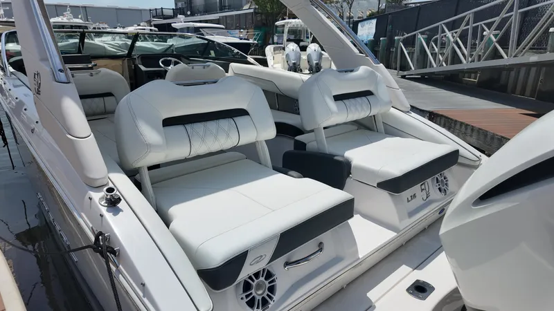 Slide: The Image of 2021 Regal LX6 boat interior with white seating and modern design at a dock. - 5