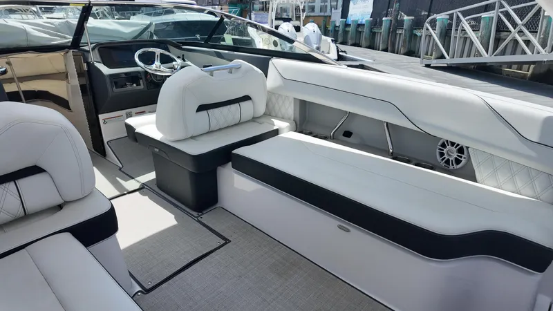 Slide: The Image of 2021 Regal LX6 boat interior with luxurious white seating and modern dashboard. - 8