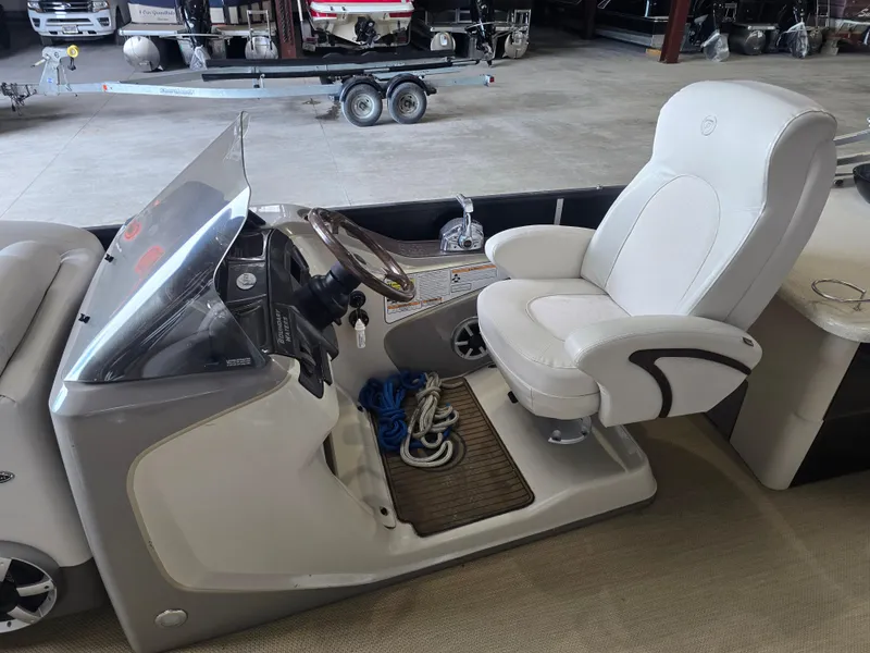 Slide: The Image of 2014 Premier 275 Boundary Waters boat interior with captain's chair and control panel. - 11