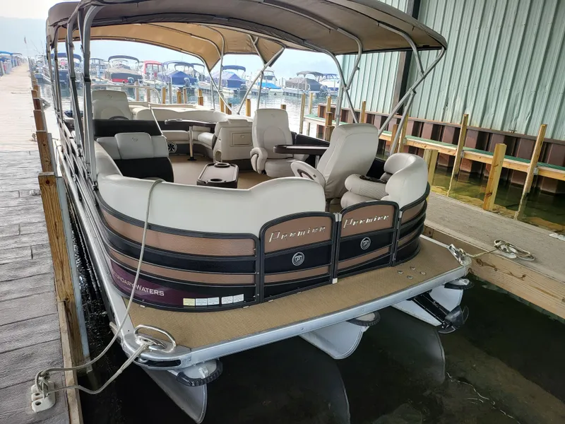 Slide: The Image of 2014 Premier 275 Boundary Waters pontoon boat docked in marina. - 2