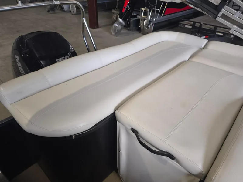 Slide: The Image of 2014 Premier 275 Boundary Waters boat with white seating and Mercury outboard motor. - 24