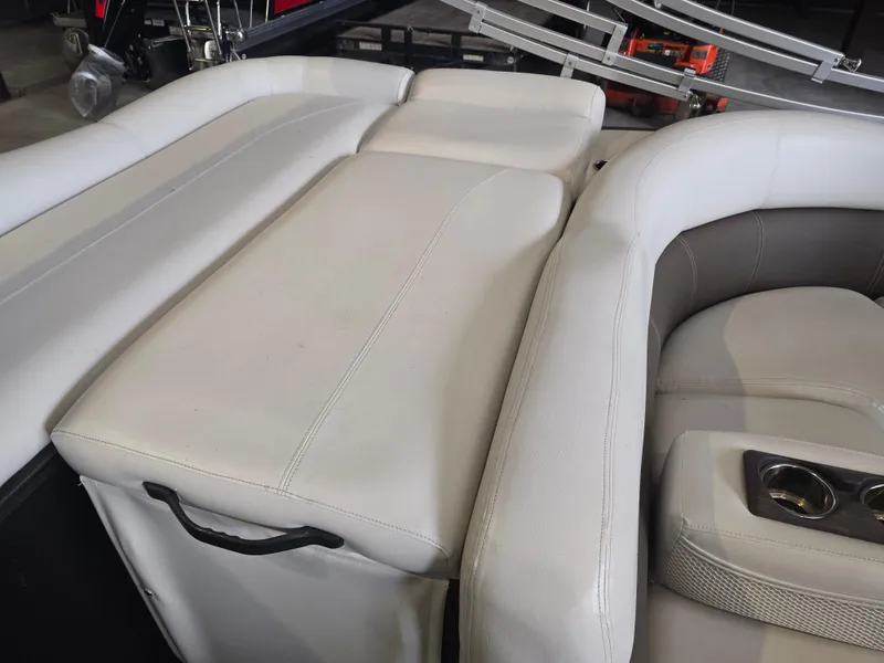 Slide: The Image of Premier 275 Boundary Waters 2014 boat interior with white leather seating and cup holders. - 25