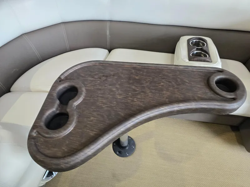 Slide: The Image of 2014 Premier 275 Boundary Waters boat interior with cup holders and wooden table. - 29