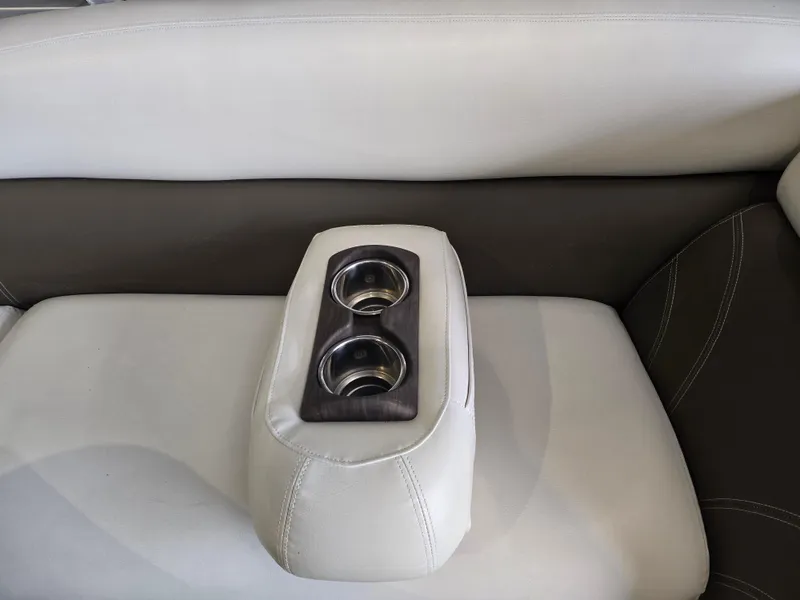 Slide: The Image of Premier 275 Boundary Waters 2014 boat seat with dual cup holders, beige and brown upholstery. - 33