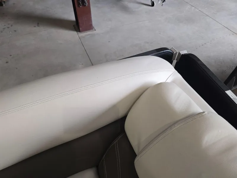 Slide: The Image of Interior seating of a 2014 Premier 275 Boundary Waters boat, featuring white upholstery. - 35