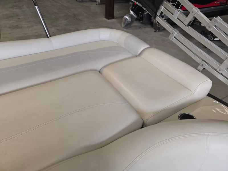 Slide: The Image of 2014 Premier 275 Boundary Waters boat with beige leather seating in a showroom. - 38