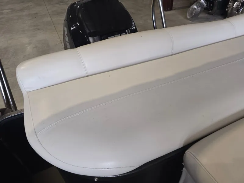 Slide: The Image of 2014 Premier 275 Boundary Waters boat seat, white upholstery, indoor setting. - 40
