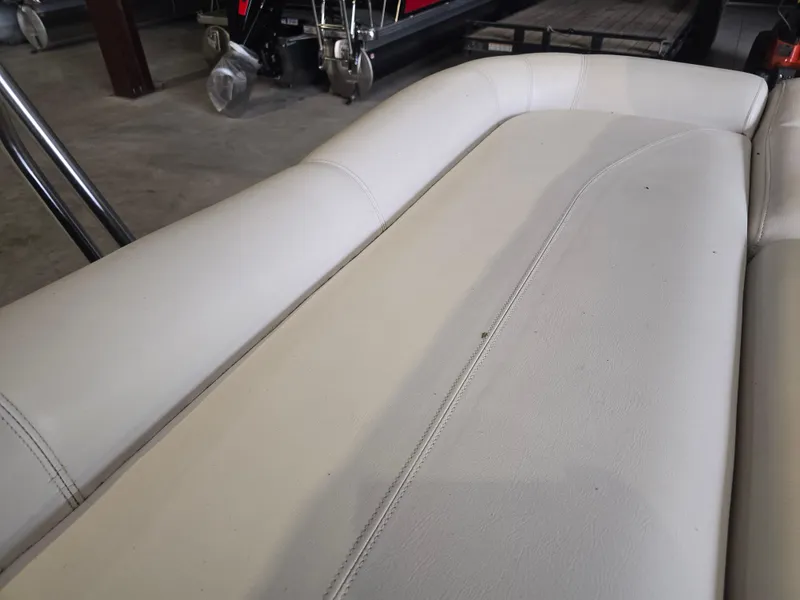 Slide: The Image of 2014 Premier 275 Boundary Waters boat seat in storage, showcasing white upholstery. - 41