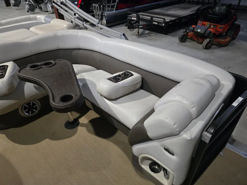 Slide: The Image of Luxurious seating on 2014 Premier 275 Boundary Waters pontoon boat with cup holders and table. - 47