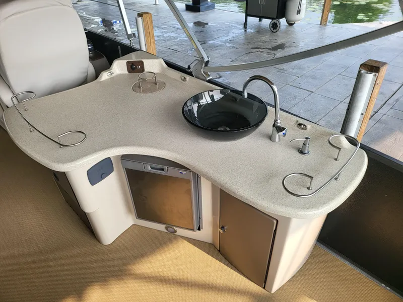 Slide: The Image of 2014 Premier 275 Boundary Waters boat interior with sink, counter, and storage. - 6